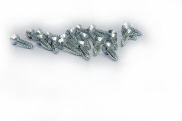 Silver screws on a white background close up

