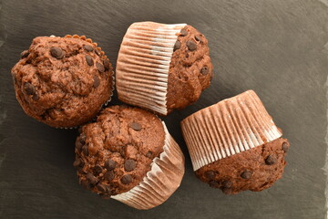 Chocolate muffins on a serving plate of slate, close-up.