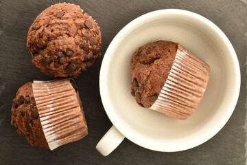 Chocolate muffins on a serving plate of slate, close-up.