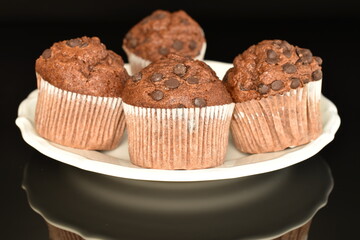 Chocolate muffins, close-up, on a black background.