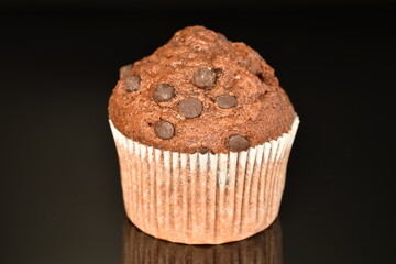 Chocolate muffins, close-up, on a black background.