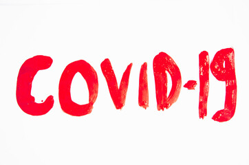 The red word COVID-19 paint on a white background