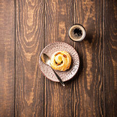 Overhead shoot of fresh pastry sweet swirl buns with raisins for breakfast or brunch and coffee. Top view, copy space.