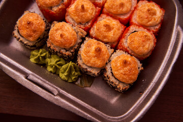 Homemade baked rice rolls in a plastic container