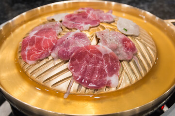 Raw meat sliced grill on hot pan, Korean barbecue or Yakiniku in japanese.