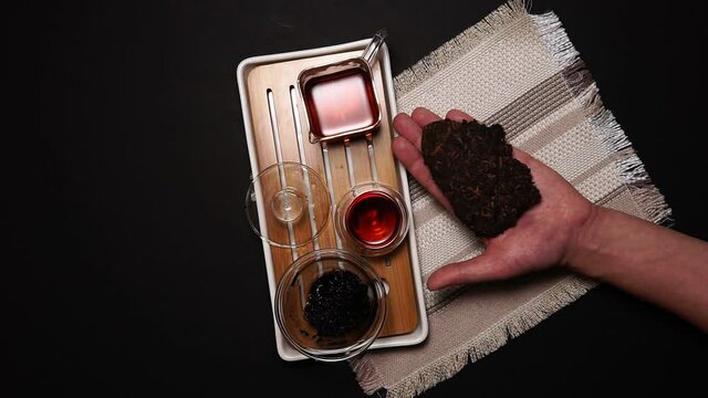 Chinese tea ceremony, shen puer tea, transparent glass, Pialats, tea set on dark table. Close up, top view concept. flat lay