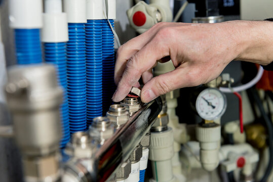 Heating Engineer Fixing Modern Heating System In Boiler Room. 