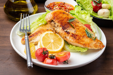 Grilled chicken breast and vegetable salad on the plate