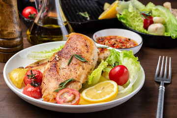 Grilled chicken breast and vegetable salad on the plate