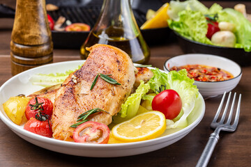 Grilled chicken breast and vegetable salad on the plate