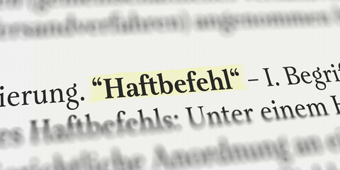 Haftbefehl im Buch mit Textmarker
