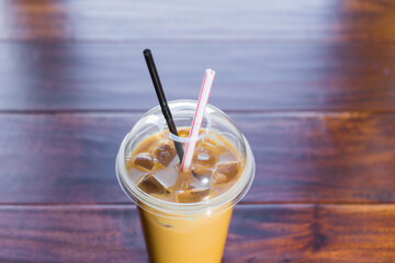 iced coffee in takeaway cup on a wooden background