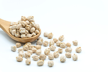 A wooden spoon of dried chickpeas on white background, Chick peas are used in many dishes, With...