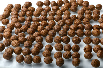 Breakfast cereal balls with chocolate on a white background
