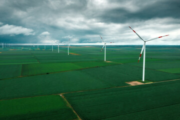 Aerial view of wind turbines on renewable green energy wind farm