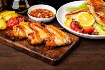 Delicious grilled chicken wings and vegetable salad