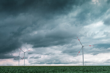 Green energy concept with wind turbines in field