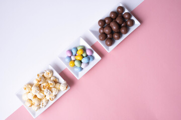 sweets in plates on a pink and white background