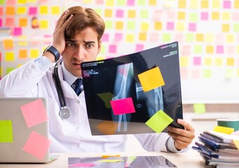 Male doctor with many conflicting prioritites