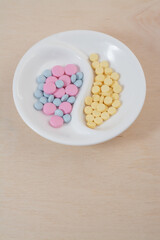 colored pills on a plate top view vertical photo