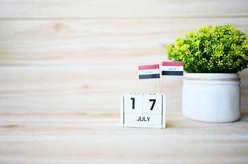 July 17 Wooden calendar and Iraq Flag Concept Iraq national day