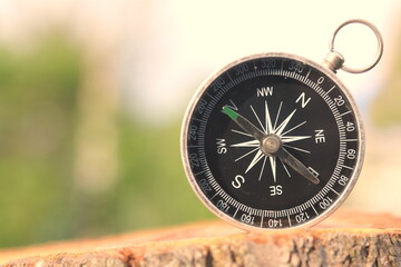 round compass on natural background as symbol of tourism with compass, travel with compass and outdoor activities with compass