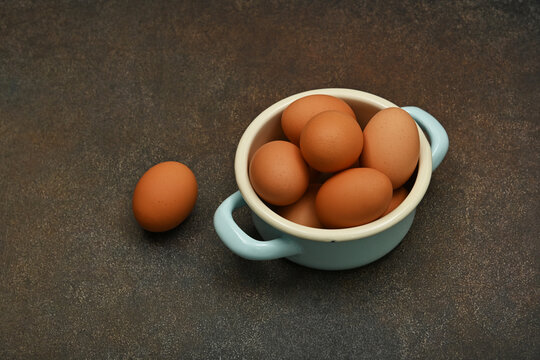 Bowl of brown chicken eggs on table