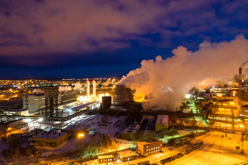 Obraz premium Night top view of a steel mill. Smog, smoke and flame from the chimneys