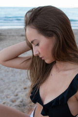 Profile portrait of a pretty young girl on the beach