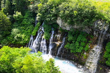 Fototapeta na wymiar Shirahige waterfall in Biei, Hokkaido, Japan during summer season.