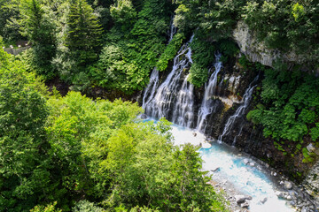 Fototapeta na wymiar Shirahige waterfall in Biei, Hokkaido, Japan during summer season.