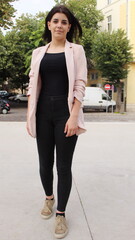 Young black haired girl on street in old part of town