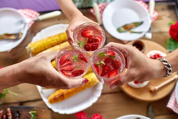 Enjoying dinner with family or friends, cheers toast with strawberry lemonade