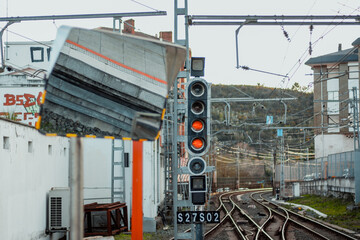 Naklejka premium Mirror at railway station with voltage lines and tracks in the background