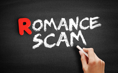 Romance scam text on blackboard, business concept background