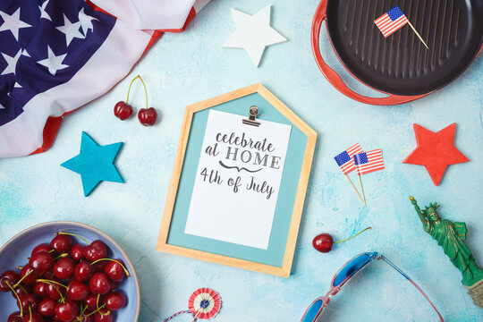 Celebrate at home 4th of July concept with photo frame and patriotic home decor. Top view from above