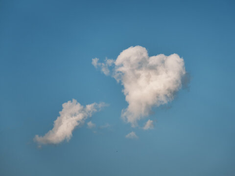 Real heart shaped cloud in blue sky