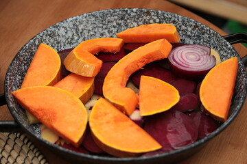 Seasonal food, fall, pumpkin, beetroot n a metal pan ready for baking, fresh, vegan, sustainable dish

