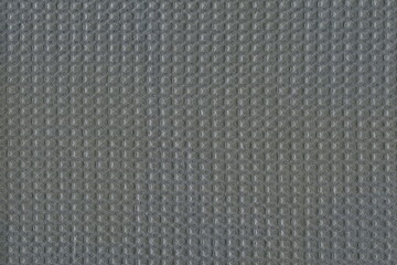 Grunge texture of a gray cotton towel in small squares. Texture of natural soft fabric. Rough matting.