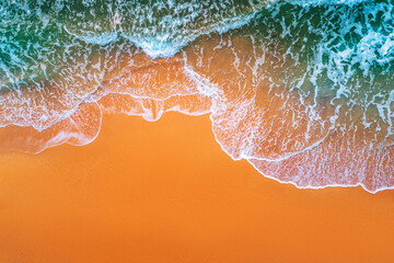 Aerial view of sea waves and sandy beach
