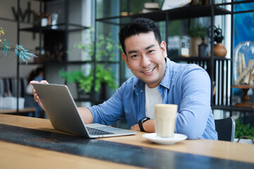 young man working on laptop in cafe