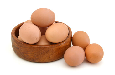 Raw eggs isolated in wooden bowl white background