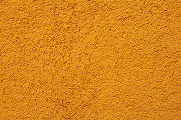 Cement wall painted yellow texture and background seamless