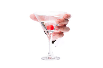 male hand with a glass of martinok with a red berry through a hole in paper on a white background isolate. close up, copy space.