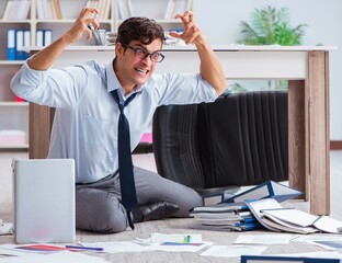 Bankrupt businessman angry in the office floor