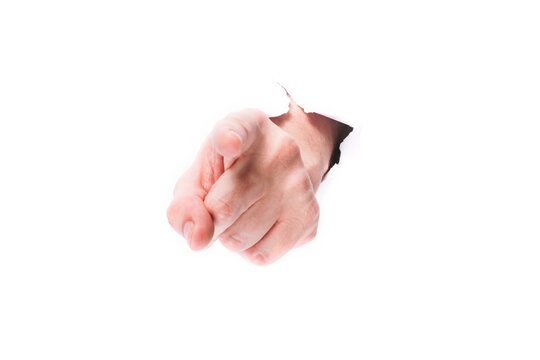 male hand showing finger through a hole in paper on a white background isolate. close up, copy space.