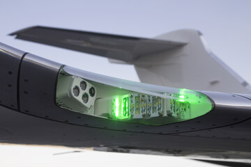 Closeup Of An Airplane Navigation Green Light On Right Side Wing