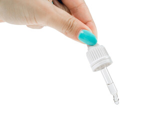 A woman's hand squeezes a clear liquid out of a pipette. Isolated on a white background.