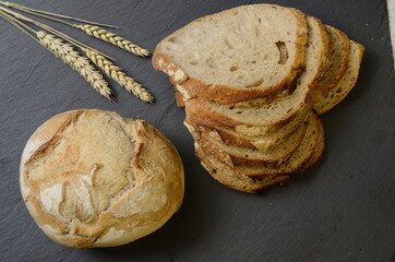 Rustic bread ball and ears of wheat