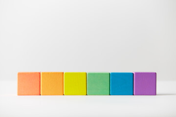 Wooden toys concept. Line of wooden blocks in colours of the gay pride rainbow flag. Perfectly lined up
